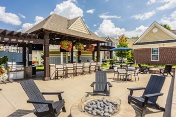 A patio area with a fire pit and seating